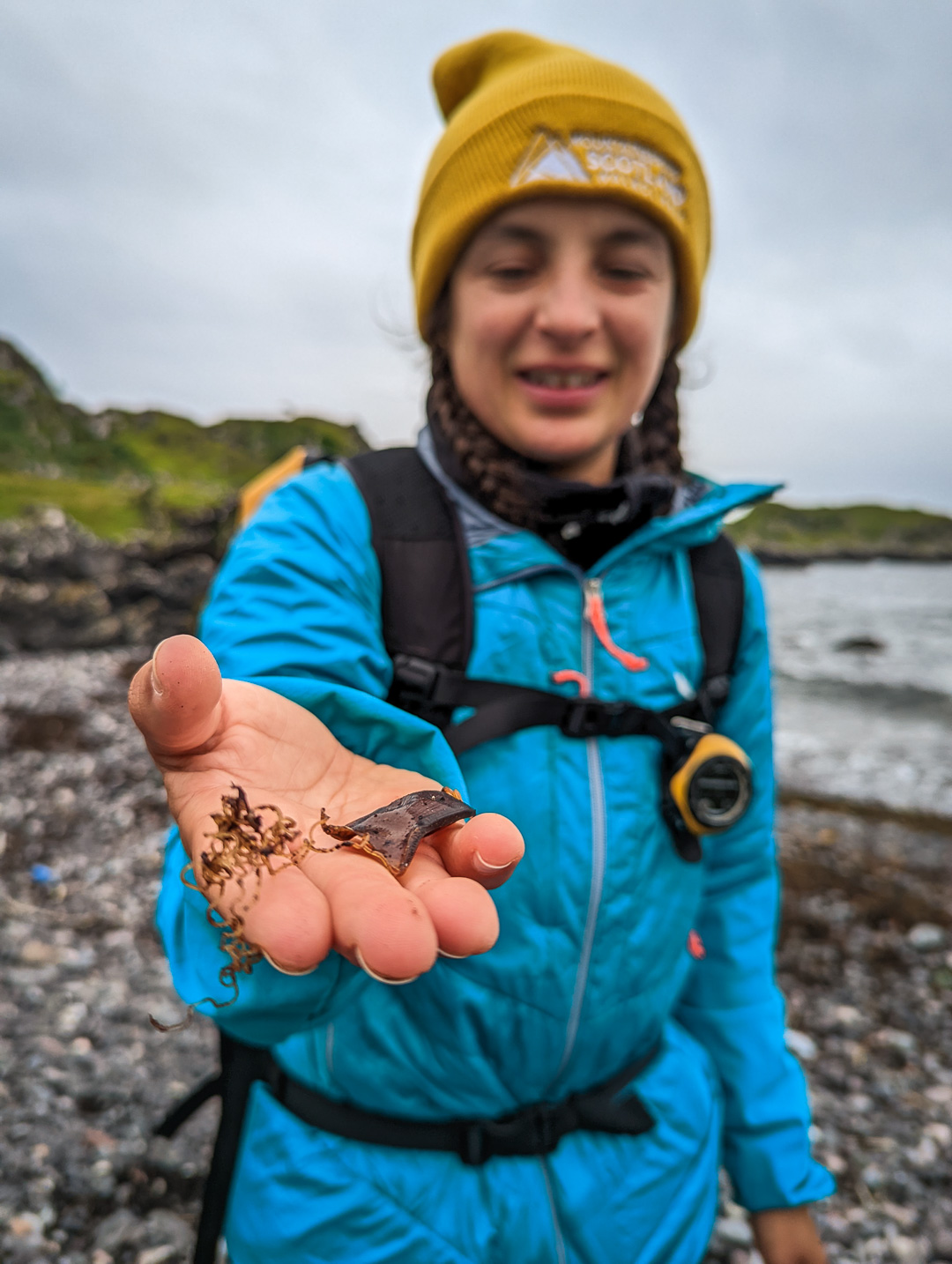 Hiking guide Kirsty Pallas holding a shark egg case on the Isle of Kerrera